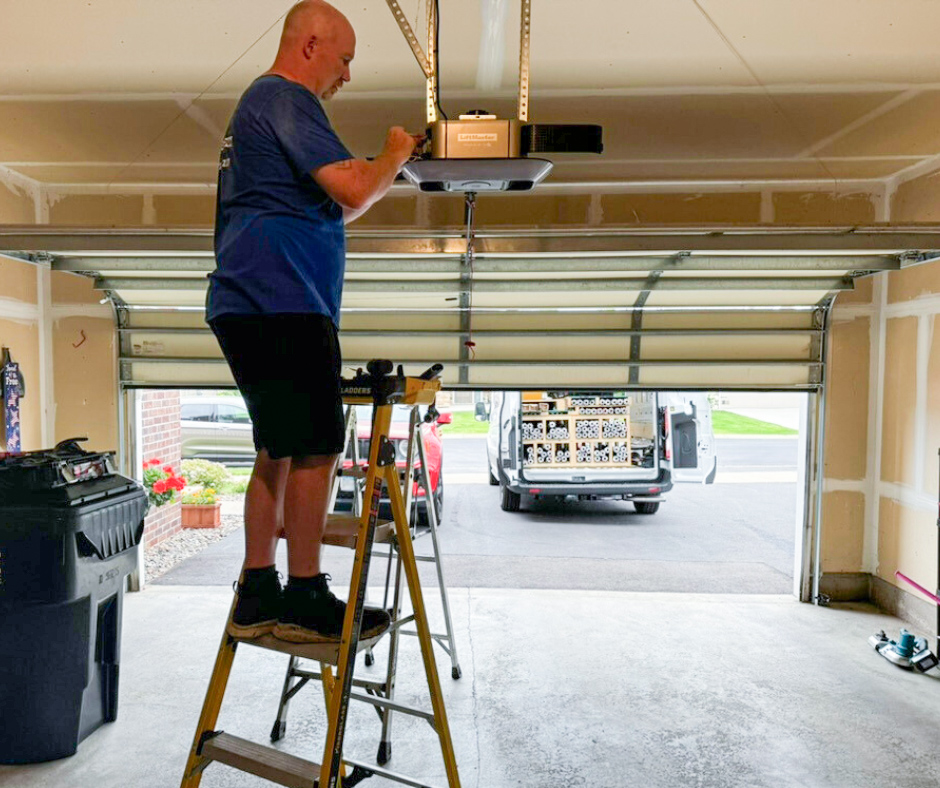 James working on a garage door opener