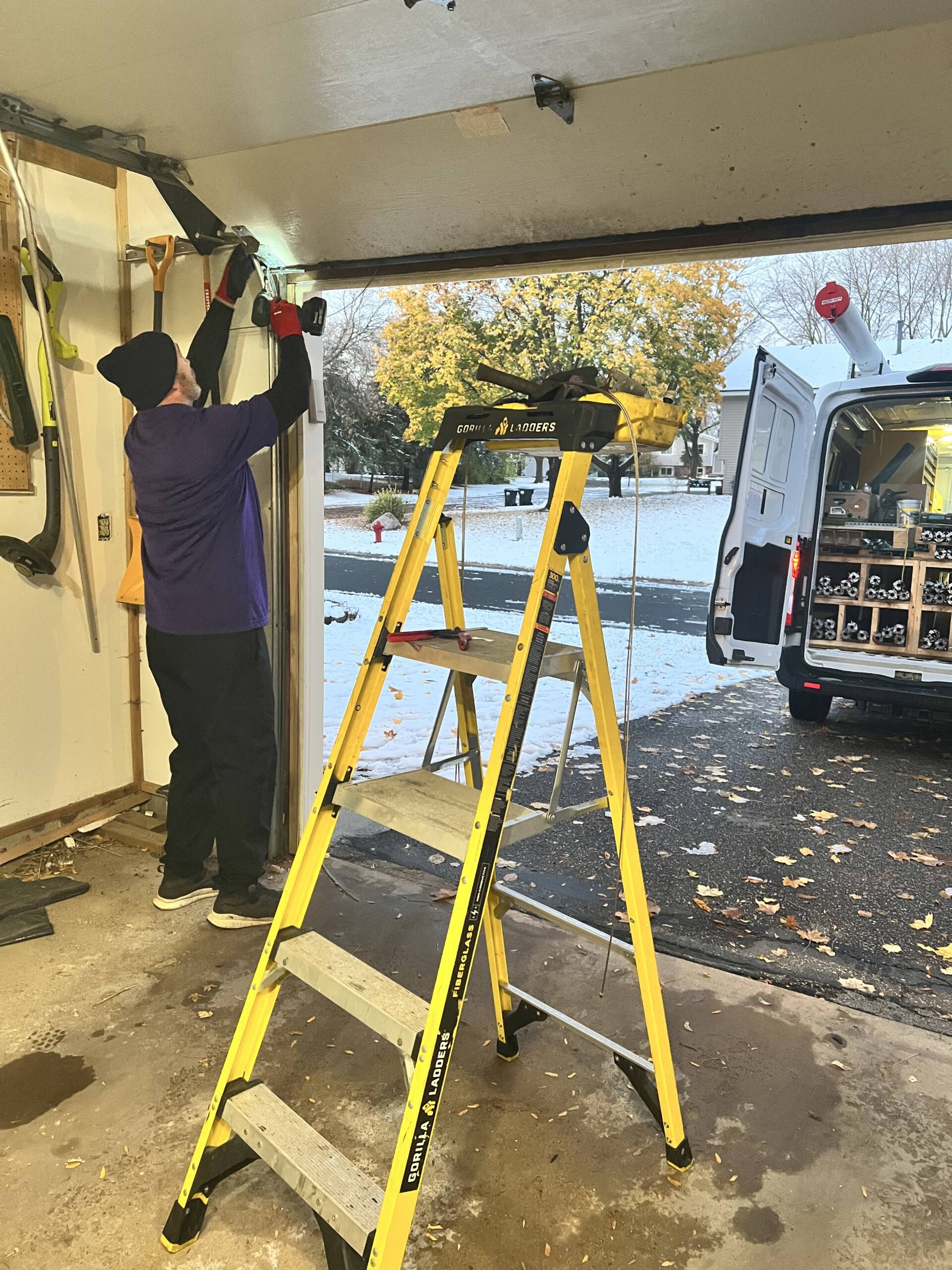 Garage door technician fixing a garage door